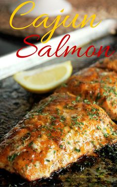 grilled salmon fillets on a grill with lemon wedges and garnish