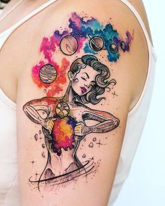 a woman's arm with an abstract tattoo design on it, and planets above her shoulder