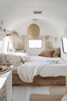 the interior of an rv with white walls and wood flooring is decorated in natural materials