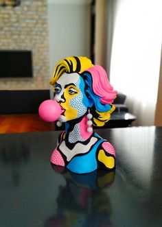 a colorfully painted figurine sitting on top of a table