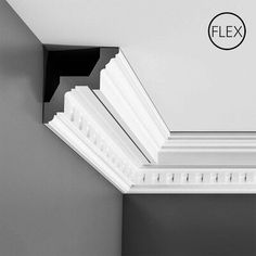 the corner of a ceiling with white trim and moldings on it's sides