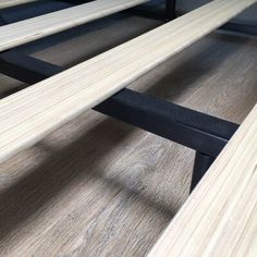 two wooden benches sitting next to each other on top of a hard wood flooring