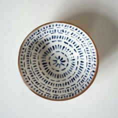 a blue and white bowl sitting on top of a table