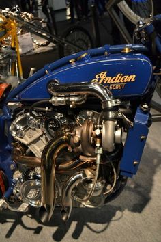 a blue motorcycle engine on display in a showroom