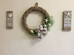 a wreath is hanging on the wall next to two other items that are hung on the wall