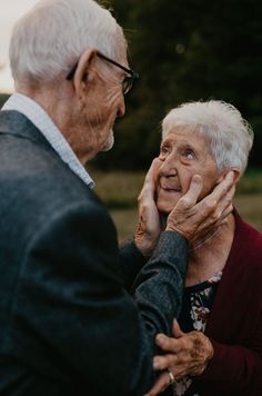 an older couple embracing each other outside