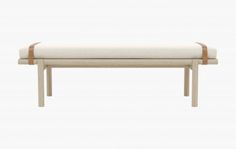 a white bench with wooden legs and a cushion on the seat is in front of a white background