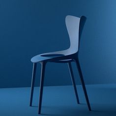 a white chair sitting on top of a blue floor