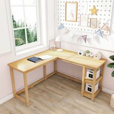 a computer desk sitting in front of a window next to a potted plant on top of a hard wood floor