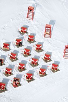 many red chairs are sitting in the snow