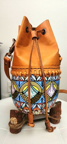 Handcrafted Art Deco Gourd Bag Description: Color:                   Copper Orange (Upper Leather), Multi-Color (Gourd) Body (Bottom):   Gourd Body (Upper):     Pure Leather Painting:              Hand painting Strap:                   Pure Leather Accessories:       Hong Kong Height:                 12 inches Circumference:   20 inches Multicolor Leather Satchel Bucket Bag, Multicolor Hand Tooled Travel Bags, Multicolor Leather Crossbody Bucket Bag, Handmade Leather Bucket Bag, Artisan Pouch Bucket Bag For Everyday Use, Multicolor Leather Bucket Bag, Multicolor Leather Pouch Satchel, Artistic Leather Satchel Shoulder Bag, Artistic Brown Bag For Daily Use