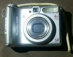 a silver camera sitting on top of a table