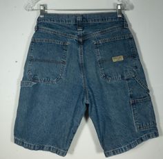 Here's a pair of classic Wrangler's jean shorts you'll love for kicking it, camping or working on projects since these jean shorts have that handy painter / carpenter cut! These late 1990's farmer's shorts have a high waist and handy front and back utility pockets and a tool loop. These classic denim shorts have the iconic Wrangler logo patch and embossed button closure. They are in great over all shape with minimal signs of wear/use and no major damage or stains. The label says they are a size Carpenter Jean Shorts Outfit, Vintage Cotton Jean Shorts For Streetwear, Retro Dark Wash Shorts With Pockets, Vintage Denim Shorts Loose, Denim Long Shorts, 90s High-waist Cotton Jean Shorts, Vintage Wrangler Jeans, Classic Denim Shorts, Hot Clothes