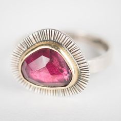 This Sorento ring features a lovely rose cut Rhodolite Garnet bezel set in 18k Gold on a hand stamped Silver plate and band. Wear this beauty in it's own or add it to your favorite ring stack. Ring is US size 9.  This ring is One-of-a-Kind. -Gemstones: rose cut Rhodolite Garnet.  -Finish: 18k Gold and oxidized Sterling Silver. -Size: head of ring measures 5/8 inch wide by just over 1/2 inch tall. Band is rectangular and is 1mm thick by 3mm wide. Ring size is US 9 and can be adjust up to 10. Elegant Faceted Tourmaline Ring, Red Tourmaline Rings Fine Jewelry, Fine Jewelry Red Tourmaline Rings, Red Tourmaline Fine Jewelry Rings, Tourmaline Rings With Rose Cut Diamonds As A Gift, Tourmaline Rings With Rose Cut Diamonds For Gift, Unique Oval Ruby Ring With Rose Cut Diamonds, Red Tourmaline Gemstone Ring, Tourmaline Rings With Rose Cut Diamonds For Anniversary