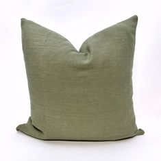 a green pillow on a white background