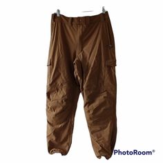 a pair of brown pants hanging on a hanger