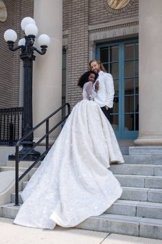 a bride and groom are standing on the steps