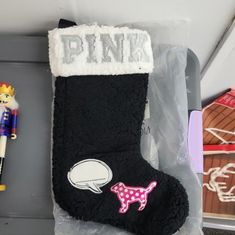 a pair of black socks sitting on top of a shelf