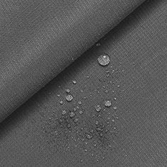 water droplets are seen on the back of a black fabric, which is very dark gray