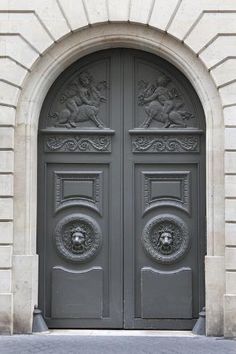 an ornate door with two lions on it