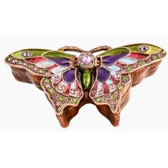 a colorful butterfly shaped brooch sitting on top of a white surface