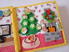 an open book with buttons and magnets on the pages, decorated like a christmas tree