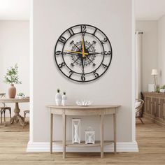 a large clock on the wall above a table in a room with wooden flooring