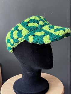 A fun summer hat that is adjustable . Handwash Summer Brimmed Crochet Hat One Size, Green Curved Brim Baseball Cap For The Beach, Green Curved Brim Baseball Cap For Beach, Casual Green Visor Sun Hat, Green Baseball Cap For Beach, Playful Summer Visor Hat, Retro Visor Baseball Cap For Spring, Retro Green Visor Baseball Cap, Adjustable Hand-knitted Mini Hats For Spring