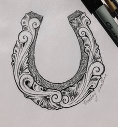 a drawing of a horseshoe with swirls on it