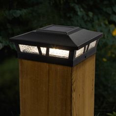 a light that is on top of a wooden post