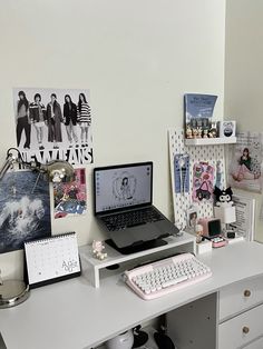 a laptop computer sitting on top of a white desk