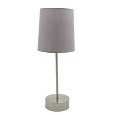 a lamp that is on top of a white surface with a gray shade over it