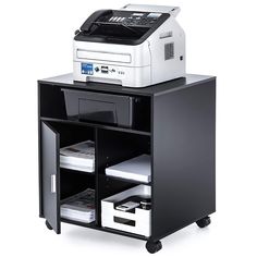 a printer sitting on top of a black and white shelf next to a printer machine