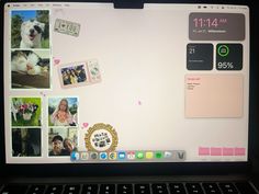 an open laptop computer sitting on top of a desk with pictures and stickers on the screen