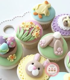 several decorated cupcakes are sitting on a table