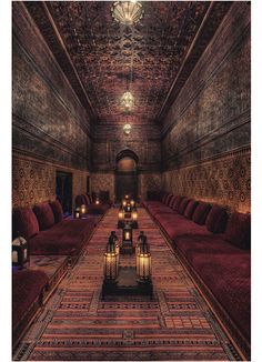 an image of a long hallway with candles on the floor and lights in the ceiling