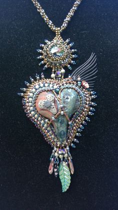 Sure to steal your heart or the heart of one you love. This raku heart pendant has so many hidden treasures!  Crystals, pearls, vintage beads, and even an eyelash add glamour and charm any time of year. Bead Projects, Vintage Beads, Creating Jewelry, Exeter, Hearts Desire, Bead Embroidery, Hidden Treasures, Hand Made Jewelry, Beaded Embroidery