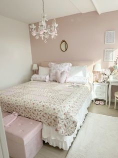 a bedroom with a bed, dresser and chandelier hanging from the ceiling above it