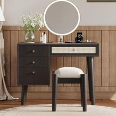 a vanity table with a mirror and stool in front of a wooden paneled wall