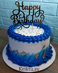 a blue and white birthday cake with the words happy birthday on it's top