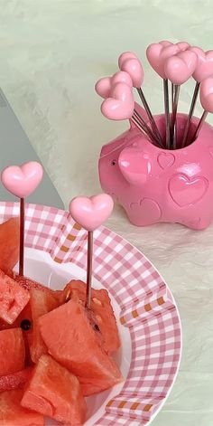 watermelon hearts on sticks in a bowl