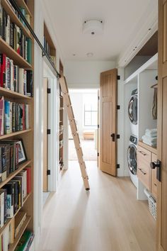 a room that has some books on the shelves and a ladder in it to go up