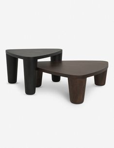 two wooden tables sitting next to each other on a white surface, one with black legs