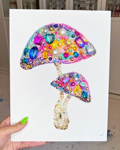 a person holding up a card with an image of a mushroom on it