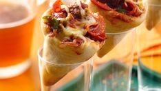 instructions for how to make pizza cones with cheese and pepperoni on them, including the toppings