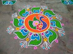 colorful rangdi work on the ground for diwaling with flowers and peacocks