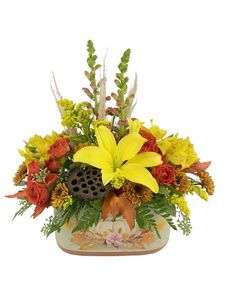 a vase filled with yellow and orange flowers