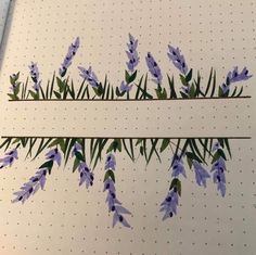 some purple flowers are on the side of a white board