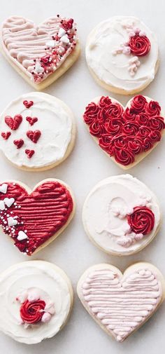 decorated cookies with red and white icing in the shape of hearts