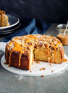 a bundt cake with caramel drizzled on top and one slice cut out